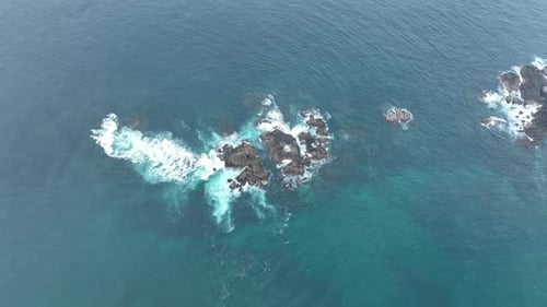 Waves Crash Against Rocks in the Ocean