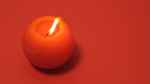 Orange Candle Flame Extinguished on Orange Background