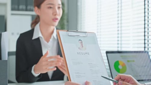 Asian beautiful woman give resume and talking with hr manager for job interview in office.