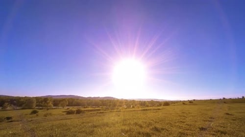 UHD Mountain Meadow Timelapse at the Summer. Clouds, Trees, Green Grass and Sun Rays Movement.