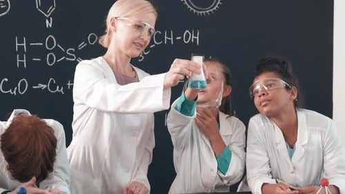 Teacher Demonstrating Science Experiment to Students in Classroom