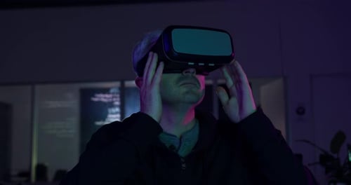 Caucasian man wearing VR headset in creative office