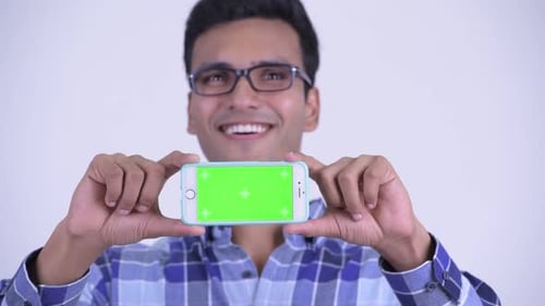 Young Man Holding Up Phone with Green Screen
