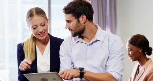 Office Workers Collaborate Using Tablet Technology