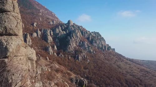 Aerial View of a Drone Flying Through Sharp Rocky Outcrops at Sunset