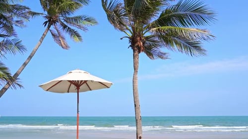 Beautiful tropical sea beach around with umbrella chair on blue sky
