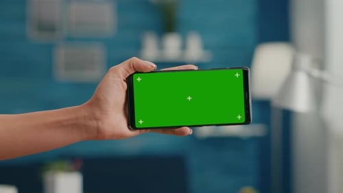 Close Up of Woman Hands Holding Horizontal Mock Up Green Screen Chroma Key Smartphone