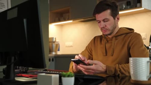 Man Working at Home Office and Use Smartphone