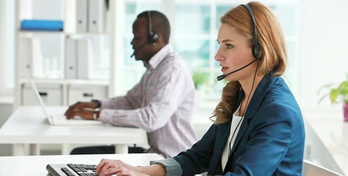 Customer Service Representatives Working in Modern Office