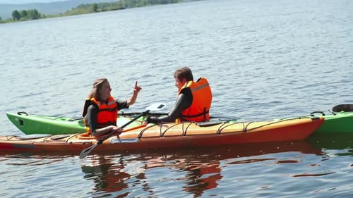 Young Couple Kayaking on a Beautiful Lake