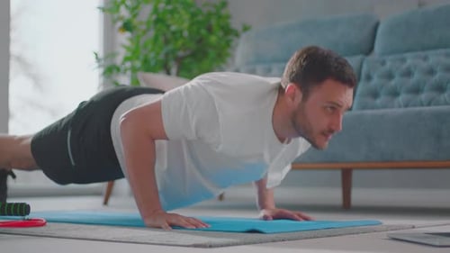 Young adult man giving push ups
