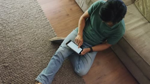 Young Adult Using Tablet at Home