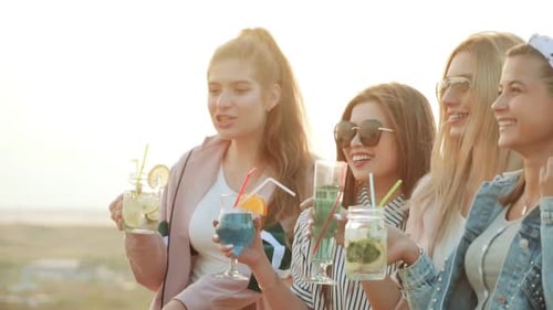 Smiling Women Enjoying Beverages Together