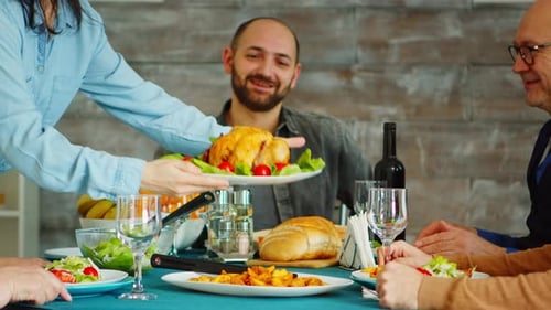 Family and Friends Gather Around Dining Table