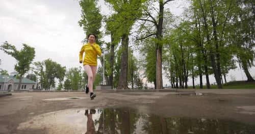 Young Woman Running In The Park