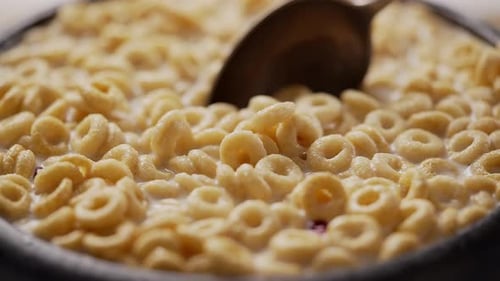 Cereal Rings with Milk Spooned from Bowl