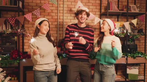 Friends Celebrate Christmas with Sparklers Indoors