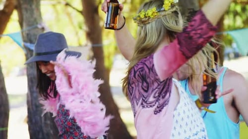 Friends Dancing and Drinking at Outdoor Party