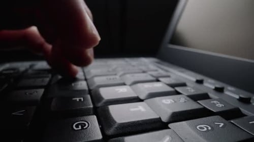 Close-up typing on keyboard with man fingers. Macro soft focus dolly shot.