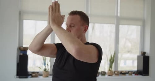 Man Practices Yoga in Serene Indoor Setting