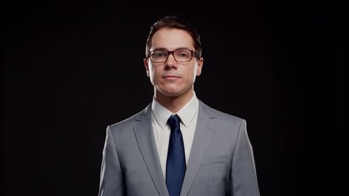 Studio portrait of successful and smart businessman in suit and tie.