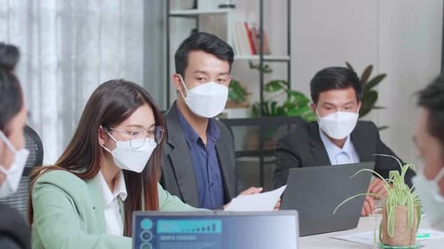 Team Meeting With Face Masks in Modern Office