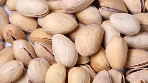 Roasted pistachios with salt rotating close-up