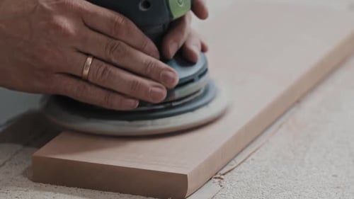 Carpentry Works Worker Makes the Top Surface of a Wooden Detail Softer with a Grinding Machine