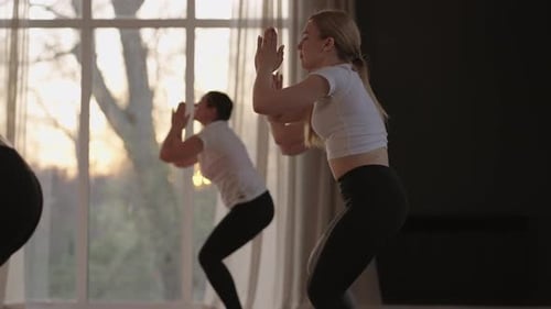 A Group of Women is Engaged in Stretching and Balance with an Instructor in a Beautiful Hall with