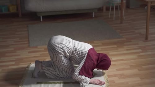 Woman Kneeling in Prayer in Living Room