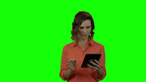 Woman Using Tablet Against Green Screen
