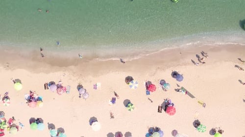 Top View of Sandy Beach with Turquoise Sea Water and Colorful Umbrellas