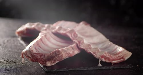 Raw Ribs Rotate Slowly on the Cutting Board.