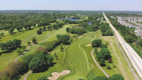 Aerial View From the Top n of the Golf Course, People and Cars on a Golf Course From a Height