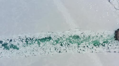 Icebreaker Ship Cutting Through Frozen Sea