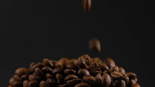 Roasted Coffee Beans Falling and Accumulating in Pile