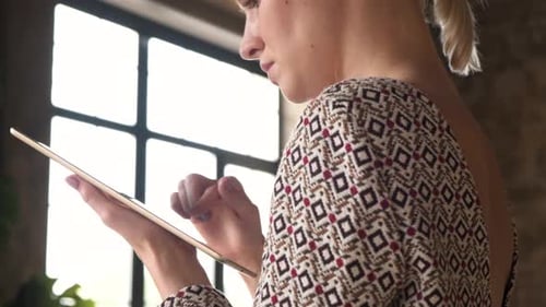 Woman Using a Tablet Device Indoors