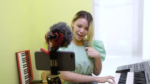 Young Woman Singing and Playing Keyboard at Home