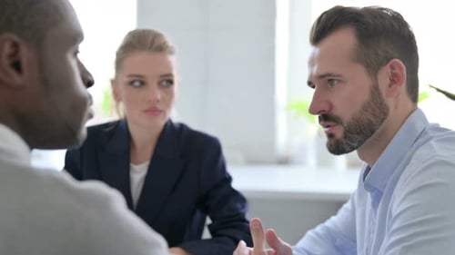 Close Up of Businessman Talking to Female and Male Business People