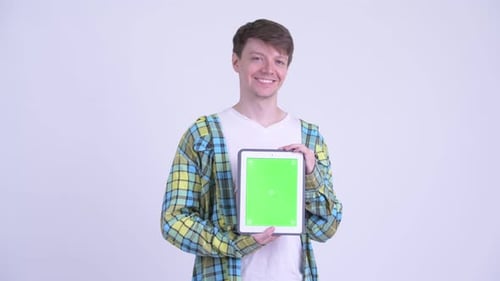 Young Adult Holding Up Green Screen Tablet