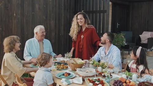 Happy Family Gathering Outdoors Sharing a Meal