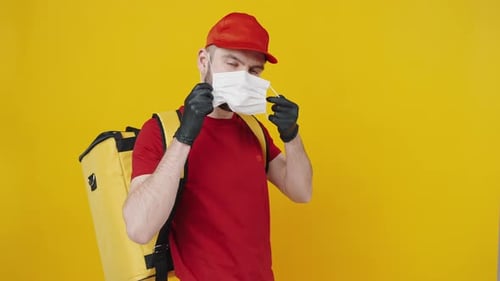 Delivery Worker Putting on Surgical Mask for Protection