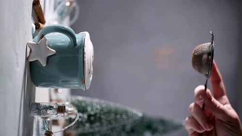 Cinnamon Powder Being Sprinkled into Cup of Coffee