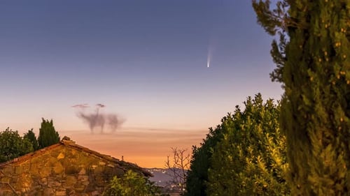 Comet Streaking Across the Night Sky at Dawn