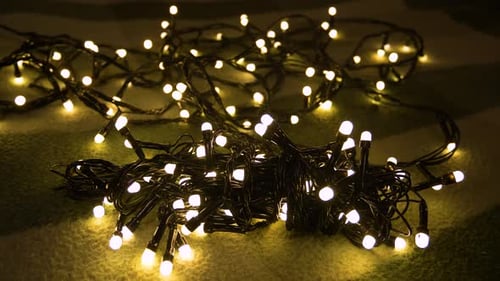 Closeup Shot Hank of Christmas Garland with Golden Lights on a Playd