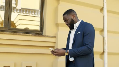 Upset African Businessman Counting Money Outdoors