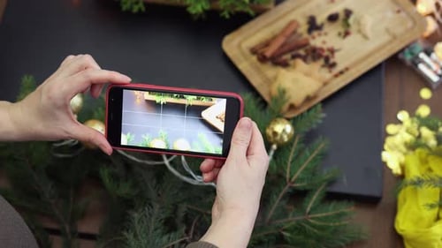 Female Hands Taking Photo Christmas Decorations Table Using Smartphone Camera