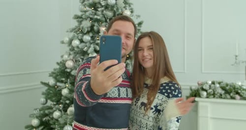 Festive Couple Celebrating Christmas with a Video Call