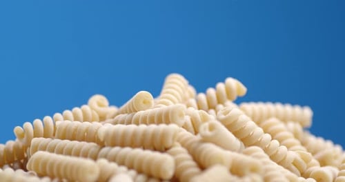 A Bunch of Dry Fusilli Pasta Rotates Slowly.