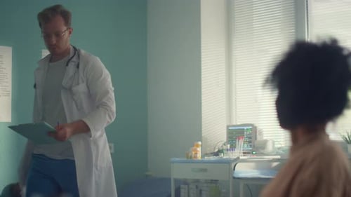 Doctor Consults with Patient and Child in Office